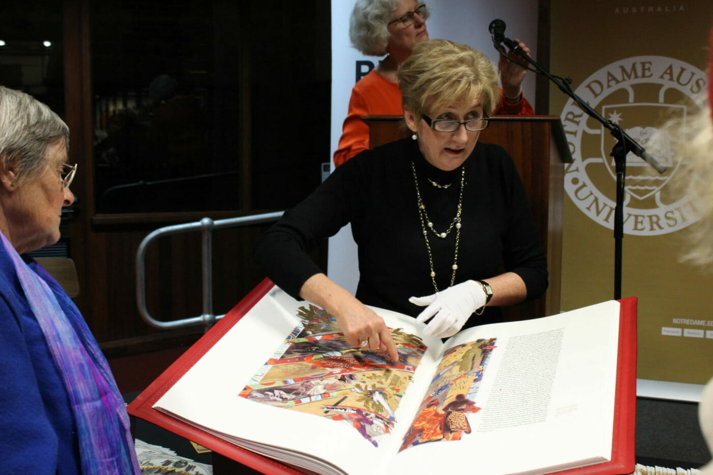 A docent from the University of Notre Dame Australia displays the Heritage Edition at the university's Festival of Religious Art.