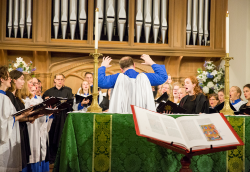 Choir performance around The Saint John's Bible at St. Luke's Parish