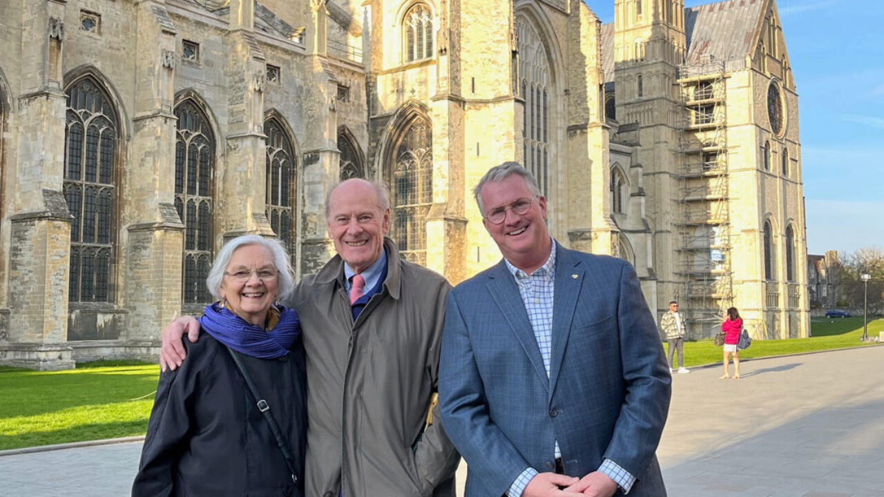 From left to right - Mabel Jackson, Donald Jackson, and Reverend John Ross stand before the Canterbury Cathedral.