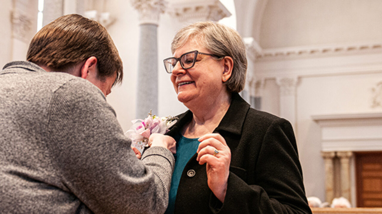 Sister Karen from Saint Benedict Monastery has a corsage put on her