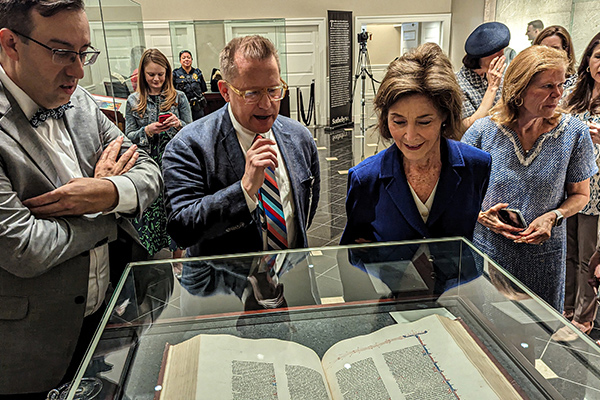 Former First Lady Laura Bush reflects on a historical text at Codex Fest