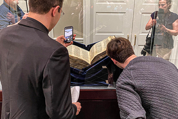 Visitors admire the Codex Sassoon behind a glass case