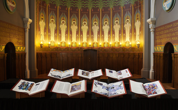 Seven volumes of The Saint John's Bible Heritage Edition lay open 