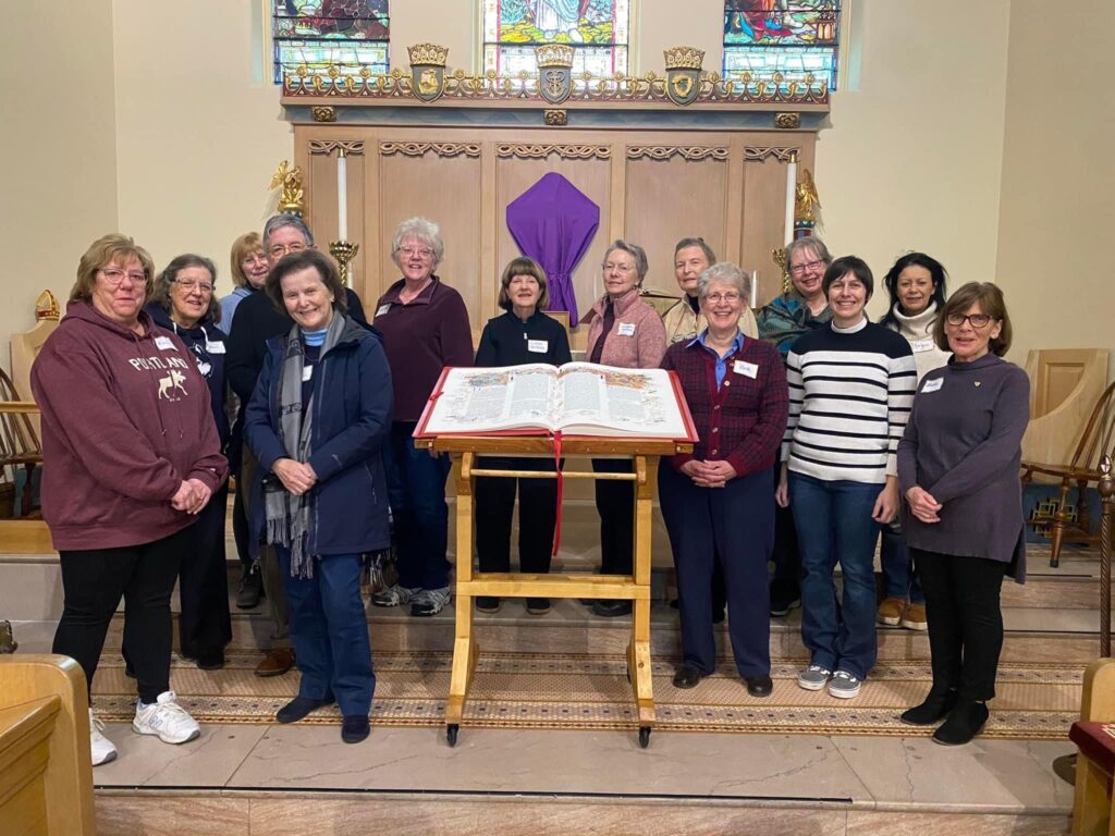 Members of St. John’s Episcopal Church standing around The Saint John's Bible Heritage Edition.