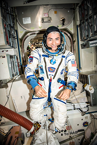 Photo courtesy of NASA: Mark Vande Hei conducts leak checks on the Sokol launch and entry pressure suit. 