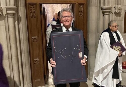 Director Brad Neary holds a volume of The Saint John's Bible Apostles Edition during the Dedication Ceremony at Washington National Cathedral.