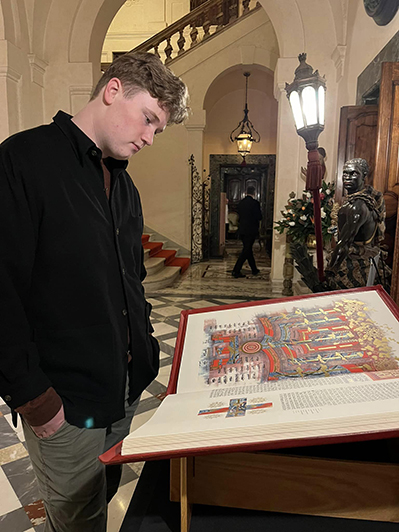 Photo by Rev. Dr. John F. Ross: The Reverend’s son, Logan, gazes upon a Heritage Edition of The Saint John’s Bible at the 2024 IFCU Conference held at LUMSA University in Rome, Italy.