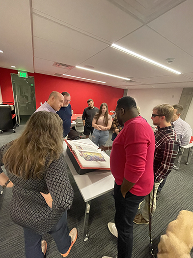 A group of nine people from Southern Methodist University experience a volume of The Saint John’s Bible Heritage Edition with Director Tim Ternes.