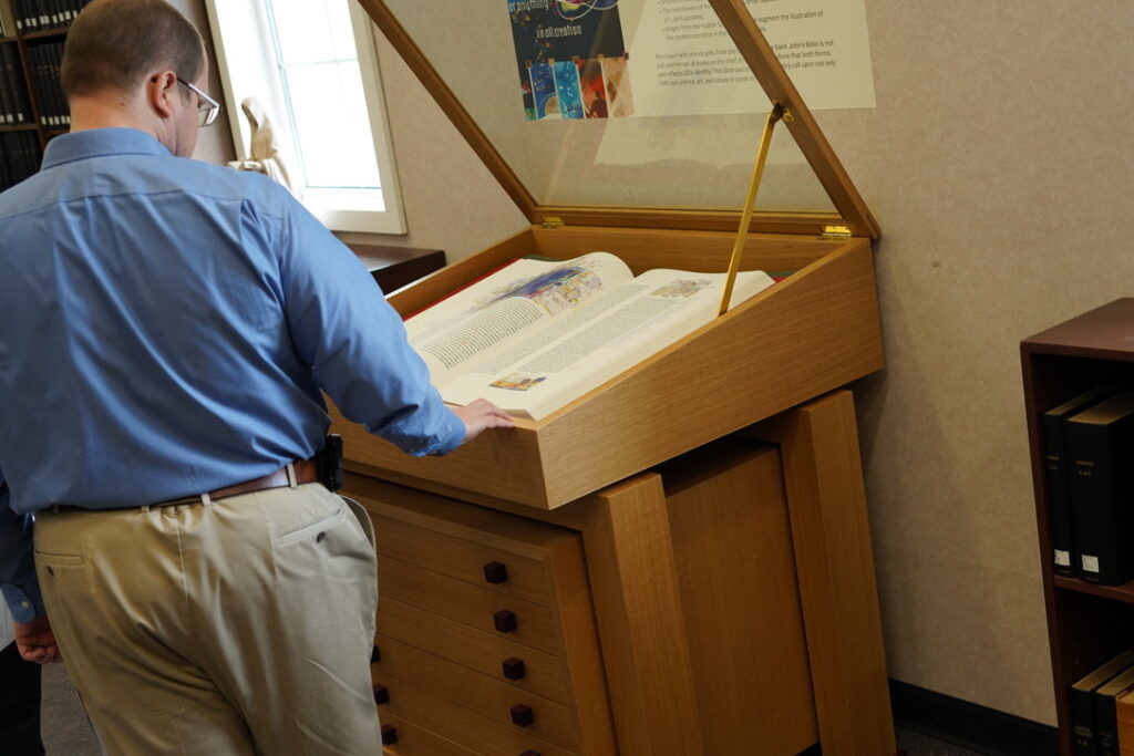 The custom case designed by Brother Gary took a handful of years to finish and now remains on the seventh floor of the Marian Library at the University of Dayton with one Heritage Edition volume The Saint John’s Bible on display and the others stored below. 