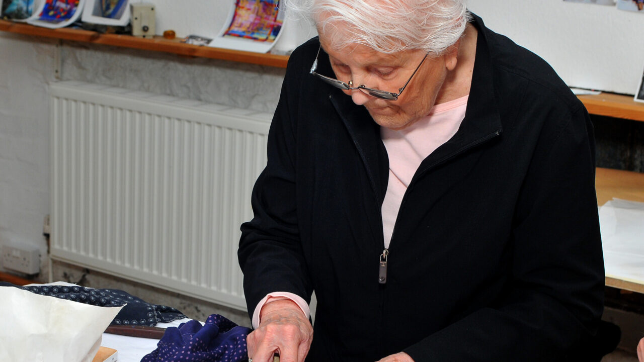 Jo White in the Scriptorium Studio in Wales, burnishing a gold detail on the final “Amen” page of The Saint John’s Bible at the time of its official completion and handover in 2013.