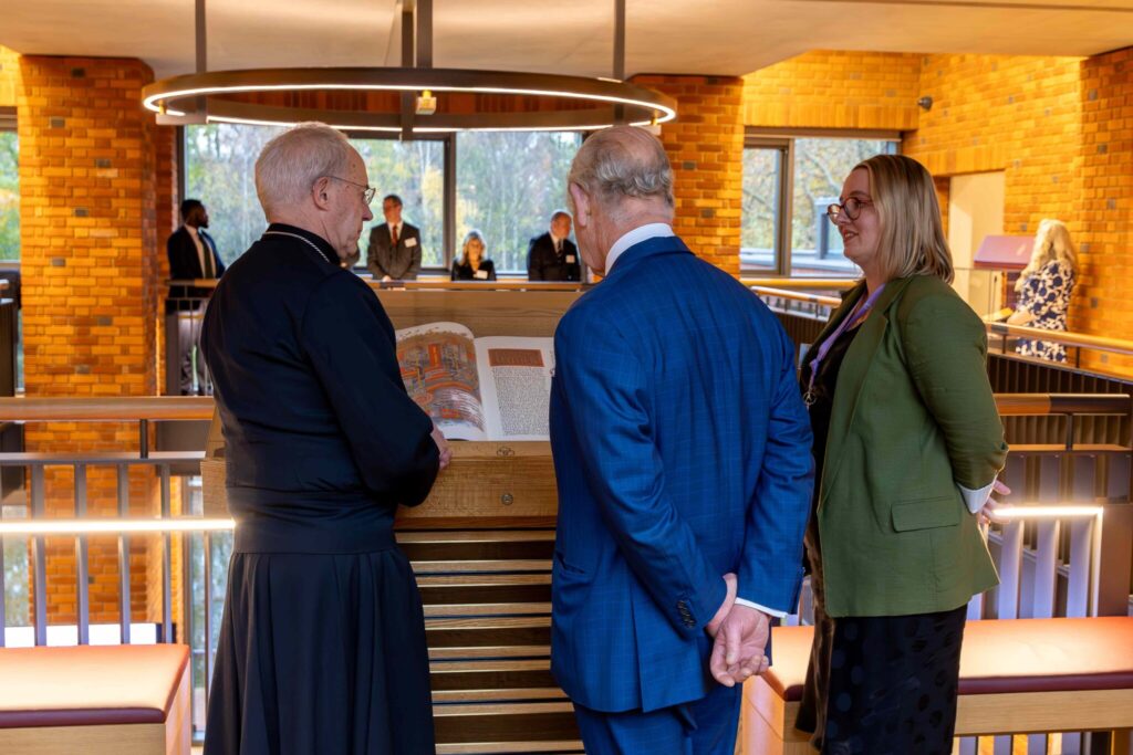 The Most Reverend Justin Welby Archbishop of Canterbury and His Majesty King Charles gaze upon one volume of Lambeth Palace Library’s Heritage Edition of The Saint John’s Bible in November 2023.