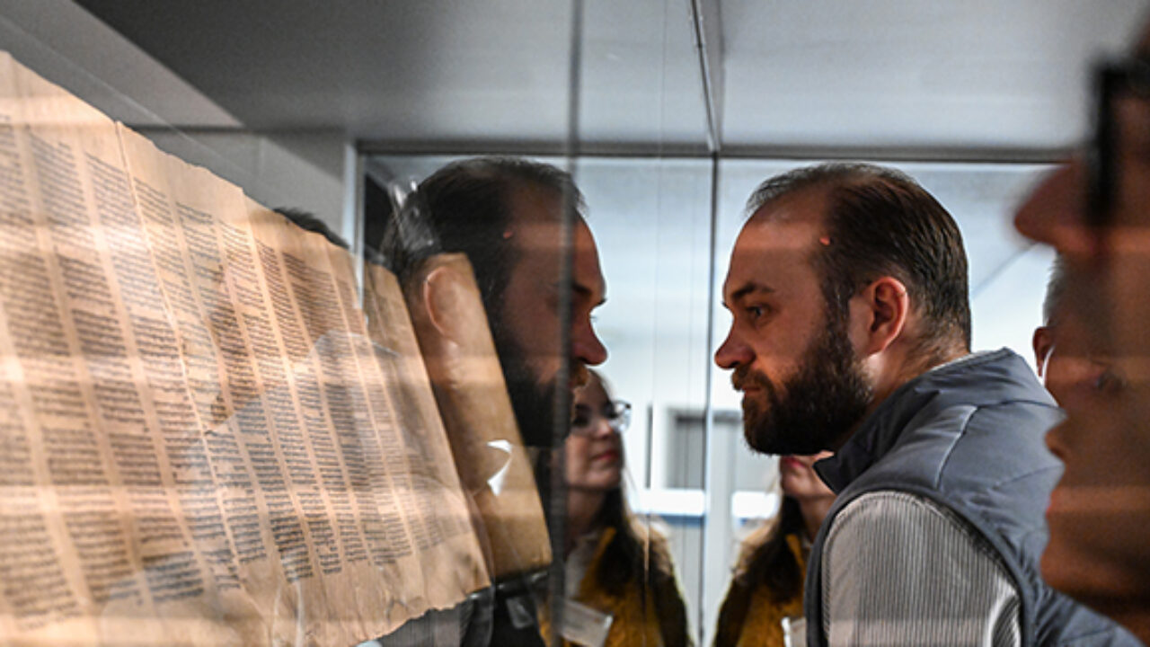 Representatives from St. Olaf College gaze upon ancient texts at the Hill Museum and Manuscript Library at Saint John’s University as part of their ‘Deep Dive’ experience to pick up the College’s Heritage Edition of The Saint John’s Bible.