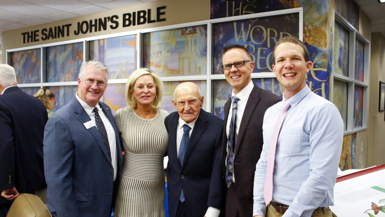 (From left to right) Executive Director of the Heritage Program Rev. Dr. John F. Ross, benefactors Kathryn Ramstad and Paul Christen, President Kittle of Dakota Wesleyan University, and Rev. Richard Anthony Purcell, PhD, Campus Pastor, stand in the new The Saint John’s Bible exhibit at the University.